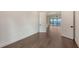 Bright living room features sleek hardwood floors and an open doorway with views of the water at 428 Bocelli Dr, North Venice, FL 34275