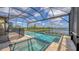 Enclosed pool area featuring a built in spa and a scenic view of the lake at 428 Bocelli Dr, North Venice, FL 34275