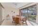 Sunroom dining area with tile floors, ceiling fan, and natural light at 4338 Center Pointe Ln # 5, Sarasota, FL 34233