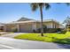 Villa exterior showing well-kept lawn and landscaping, attached garage, and mature palm trees at 4338 Center Pointe Ln # 5, Sarasota, FL 34233