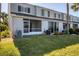 Exterior view of the back of the home featuring a lawn and screened-in patio at 4717 Sabal Key Dr, Bradenton, FL 34203