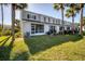 Backyard with a lush green lawn and tropical landscaping at 4717 Sabal Key Dr, Bradenton, FL 34203