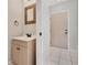 Hallway featuring a sink, decorative mirror, and an entry door to the property at 4717 Sabal Key Dr, Bradenton, FL 34203