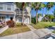 Charming townhome with well-kept lawn, sidewalk, and beautiful palm trees in the front yard at 4717 Sabal Key Dr, Bradenton, FL 34203