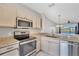 Modern kitchen with stainless steel appliances, granite countertops, and ample cabinet space at 4717 Sabal Key Dr, Bradenton, FL 34203