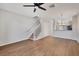Bright living room with hardwood floors, ceiling fan, and staircase leading upstairs at 4717 Sabal Key Dr, Bradenton, FL 34203