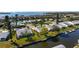 Aerial view of home with canal access, dock, and well-manicured lawn at 4721 Mount Vernon Dr, Bradenton, FL 34210
