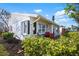 Exterior view of home with a well maintained yard, patio table and chairs at 4721 Mount Vernon Dr, Bradenton, FL 34210