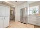 Bright kitchen with white cabinets, stainless steel refrigerator, and ample counter space at 4721 Mount Vernon Dr, Bradenton, FL 34210