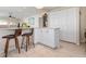 Open kitchen with bar seating, white cabinetry and tile flooring at 4721 Mount Vernon Dr, Bradenton, FL 34210