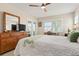 Main bedroom features a ceiling fan, dresser, and bright natural light at 4721 Mount Vernon Dr, Bradenton, FL 34210