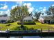 Charming waterfront home with a private dock, lush lawn, and mature trees under a sunny sky at 4721 Mount Vernon Dr, Bradenton, FL 34210