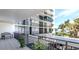 Relaxing balcony view overlooking the ocean with seating and tropical palm trees at 4822 Ocean Blvd # 2D, Sarasota, FL 34242