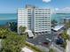 Exterior view of a high-rise building near the water, with a well-maintained parking area and lush landscaping at 4822 Ocean Blvd # 2D, Sarasota, FL 34242