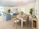 Bright dining room featuring ample seating, tile floors, and serene beach-themed decor at 4822 Ocean Blvd # 2D, Sarasota, FL 34242
