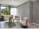 Modern lobby area with stylish seating, a glass table, decorative accents, and abundant natural light at 4822 Ocean Blvd # 2D, Sarasota, FL 34242