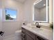 Well-lit bathroom with a large vanity mirror and modern fixtures at 501 Reclinata Dr, Longboat Key, FL 34228