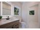 Bathroom features an illuminated mirror, modern vanity, and a large window at 501 Reclinata Dr, Longboat Key, FL 34228