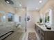 Spa-like bathroom featuring a frameless glass shower, dual vanities, and modern fixtures at 501 Reclinata Dr, Longboat Key, FL 34228