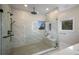 Modern bathroom features frameless glass shower, rain head, marble walls, and built-in bench at 501 Reclinata Dr, Longboat Key, FL 34228