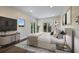 Staged bedroom with sleek furniture, modern decor, and balcony access with a treed view at 501 Reclinata Dr, Longboat Key, FL 34228