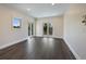 Open and airy bedroom with recessed lights, wood floors, and access to a private balcony at 501 Reclinata Dr, Longboat Key, FL 34228