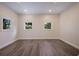 Bright bedroom with three large windows and luxury vinyl plank flooring at 501 Reclinata Dr, Longboat Key, FL 34228