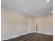 Bright bedroom featuring wood floors, recessed lighting, white trim and paneled door at 501 Reclinata Dr, Longboat Key, FL 34228