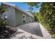 Exterior view of a light blue two-story home with a white gravel driveway at 501 Reclinata Dr, Longboat Key, FL 34228