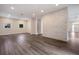 Living room featuring gray wood floors, recessed lighting and a modern stacked stone accent wall at 501 Reclinata Dr, Longboat Key, FL 34228