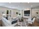 Bright living room features a modern fireplace, recessed lighting, and access to the outdoor pool area at 501 Reclinata Dr, Longboat Key, FL 34228