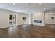 Bright living room features a modern fireplace, recessed lighting, and hardwood flooring at 501 Reclinata Dr, Longboat Key, FL 34228