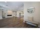 Bright, open-concept living space with hardwood floors and a modern fireplace at 501 Reclinata Dr, Longboat Key, FL 34228