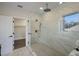 Modern bathroom with frameless glass shower, rain shower head, and elegant tile at 501 Reclinata Dr, Longboat Key, FL 34228