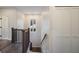 Stairway features modern white trim and a wood railing at 501 Reclinata Dr, Longboat Key, FL 34228