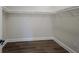 Bright, minimalist walk-in closet with white shelving, trim, and modern flooring at 501 Reclinata Dr, Longboat Key, FL 34228