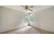 Empty bedroom with carpet flooring, ceiling fan and two windows at 5011 Windsor Park, Sarasota, FL 34235