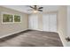 Bedroom featuring a large window, dual closets, and wood-look flooring at 5470 Ansonia Ter, North Port, FL 34287