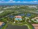 Aerial view of community amenities featuring a pool, tennis courts, clubhouse, and well-manicured landscaping at 5556 Cantucci St, Nokomis, FL 34275