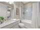 Bright bathroom featuring blue tile accents and a shower-tub combination at 5556 Cantucci St, Nokomis, FL 34275