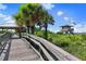 Wooden boardwalk leading to a sandy beach with a lifeguard tower at 5556 Cantucci St, Nokomis, FL 34275