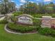 Bellacina by Casey Key community entrance featuring manicured landscaping and a stone welcome sign at 5556 Cantucci St, Nokomis, FL 34275