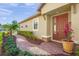 Beautiful home entrance with well manicured landscaping and a brick walkway to the front door at 5556 Cantucci St, Nokomis, FL 34275