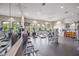 Community fitness center featuring modern exercise equipment, mirrors, and plenty of natural light at 5556 Cantucci St, Nokomis, FL 34275