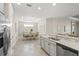 Open-concept kitchen and dining area with granite countertops, stainless steel appliances, and tile flooring at 5556 Cantucci St, Nokomis, FL 34275