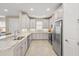 Bright kitchen with white cabinets, granite countertops, stainless steel appliances, and tile flooring at 5556 Cantucci St, Nokomis, FL 34275
