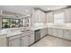 Spacious kitchen boasting stainless steel appliances, granite countertops, white cabinetry, and tile floors at 5556 Cantucci St, Nokomis, FL 34275