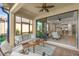 Relaxing screened-in lanai with comfortable seating, tile flooring, and view of the open living room at 5556 Cantucci St, Nokomis, FL 34275