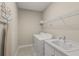 Functional laundry room with a washer, dryer, and a utility sink at 5556 Cantucci St, Nokomis, FL 34275