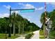 Image of The Legacy Trail with trees and blue skies with a marked cross walk and signage on a sunny day at 5556 Cantucci St, Nokomis, FL 34275